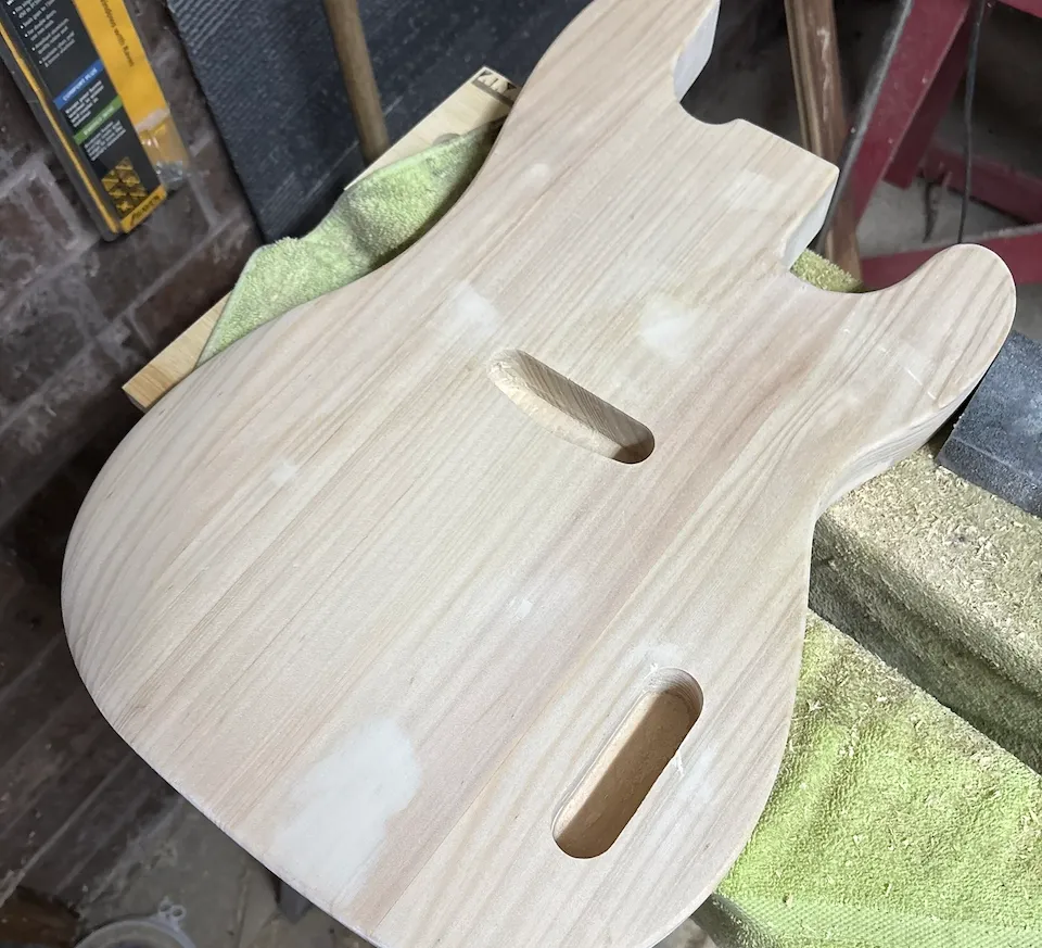 50s-style P bass body on a workbench